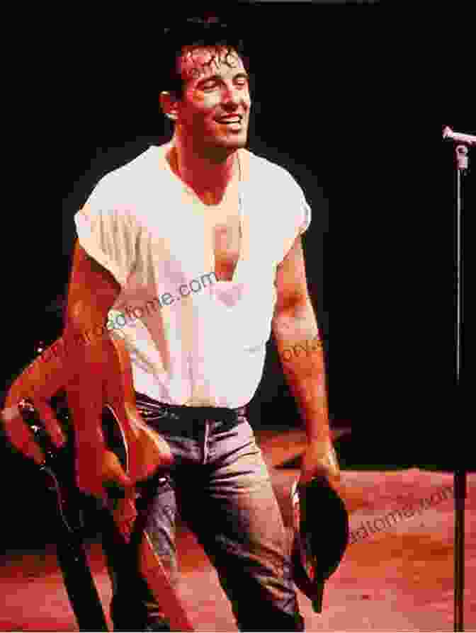 A Black And White Portrait Of Bruce Springsteen, Looking Intense And Holding A Guitar. ICONS Lawrence Grobel