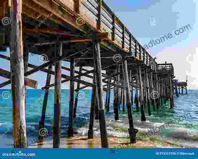 A Majestic Seaside Pier Stretching Out Into The Sparkling Sea, With People Strolling Along Its Wooden Planks And Enjoying The Vibrant Atmosphere. Seaside Piers From Suffolk To Devon